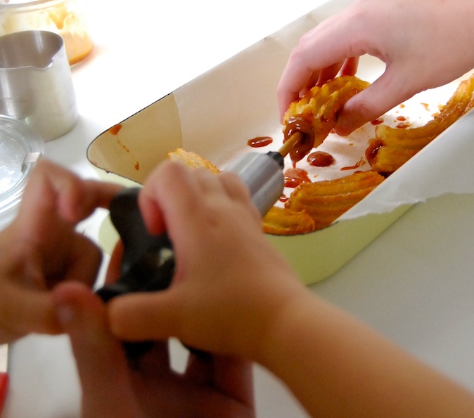 filling churros with Dulce de Leche